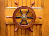 A seemingly incongruous nautical reference in a building dedicated to the sky, this wheel once guided the telescope to its focal points in the heavens. Now retired, it adorns the door to physics and astronomy professor Mel Ulmer's office on the first floor. 